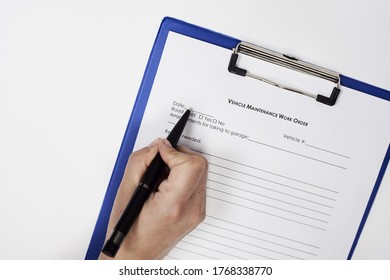 A Closeup Of A Person Signing A Vehicle Maintenance Work Order Form