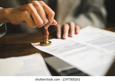 Close-up of person stamping documents to approve agreements, - Shutterstock ID 2197300261