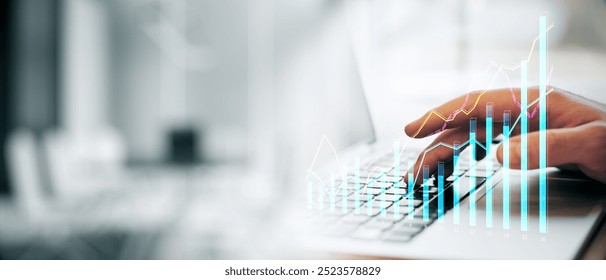 Closeup of a person typing on a laptop keyboard with financial graphs overlayed, in a modern office setting, concept of analyzing data - Powered by Shutterstock