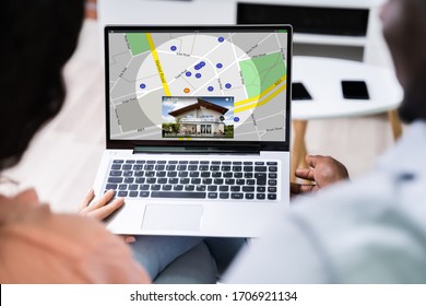 Close-up Of A Person Using GPS Map With Navigation Pointers On Laptop At Office