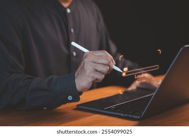 Close-up of a person using a pen with a laptop, highlighting a glowing loading bar and digital interface, representing technology, progress, and innovation. - Powered by Shutterstock