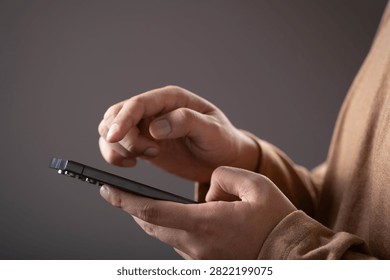 Close-up of a person using a smartphone with touchscreen interaction. Concept of mobile technology, digital communication, online services, app usage, connectivity, and modern lifestyle.