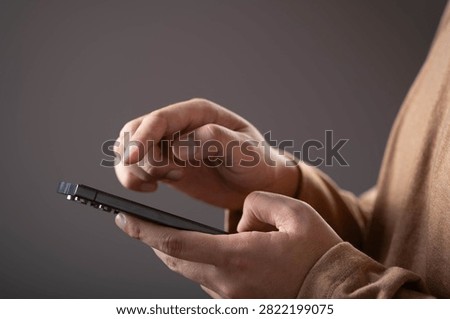 Close-up of a person using a smartphone with touchscreen interaction. Concept of mobile technology, digital communication, online services, app usage, connectivity, and modern lifestyle.