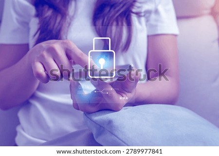 Close-up of a person using smartphone with virtual lock interface representing mobile security, data privacy and secure acces