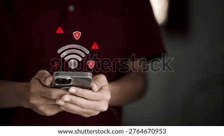 Close-up of person using smartphone with weak WiFi signal, warning alerts, and security risk icons, representing network failure, cybersecurity threats, data breach, and unstable internet connection.