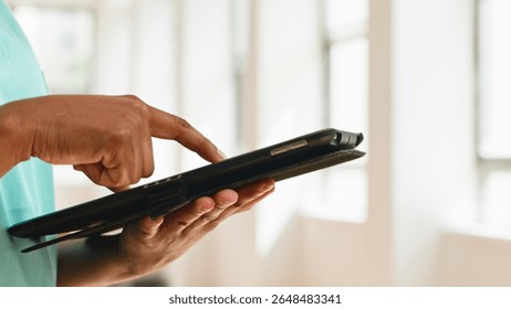 Close-Up of a Person Using a Tablet Device in a Modern Bright Environment