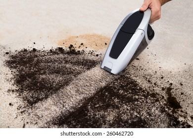 Close-up Of A Person Vacuuming Dirt Mess On Caret