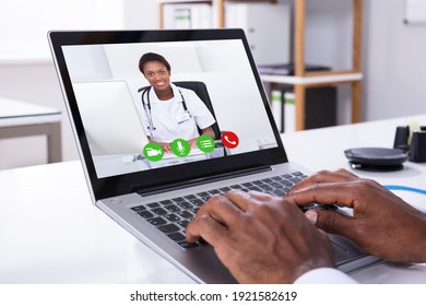 Close-up Of A Person Video Conferencing With Female Doctor Through Laptop - Shutterstock ID 1921582619