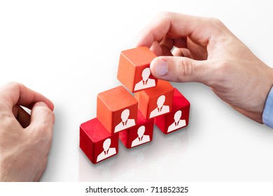 Close-up Of A Person's Hand Building Blocks Of Team