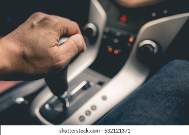 Close-up Of Person's Hand Changing Gear While Driving Car