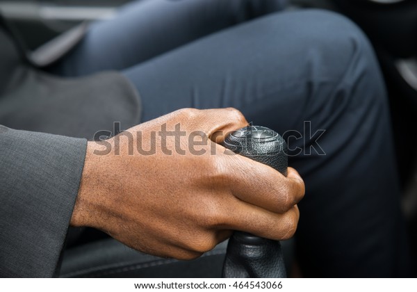 Close-up\
Of Person\'s Hand Changing Gear While Driving\
Car