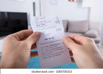 Close-up Of Person's Hand Holding Bill At Home