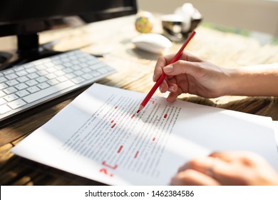 Close-up Of A Person's Hand Marking Error With Red Marker On Document - Shutterstock ID 1462384586