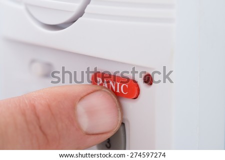 Close-up Of Person's Hand Pressing Panic Button