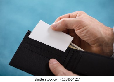 Close-up Of A Person's Hand Removing Blank White Card From Wallet