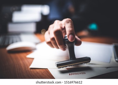Close-up Of A Person's Hand Stamping With Approved Stamp On Text Approved Document At Desk,  Contract Form Paper - Shutterstock ID 1516976612