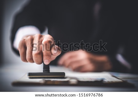 Close-up Of A Person's Hand Stamping With Approved Stamp On Text Approved Document At Desk,  Contract Form Paper