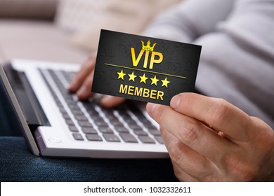 Close-up Of A Person's Hand Using Laptop Holding Vip Member Card