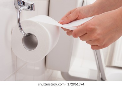 Close-up Of A Person's Hand Using Toilet Paper