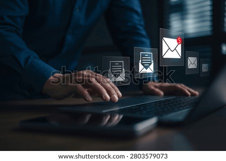 Close-up of a person's hands using a laptop with virtual email and message notification icons floating above, showing 5 unread messages. Represents digital communication, business technology, and online connectivity in a modern dark setting.