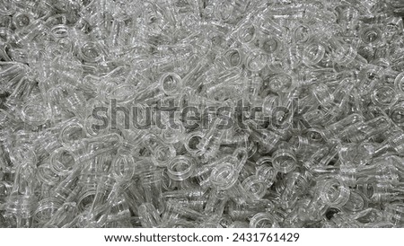 Close-Up of PET Preforms: Pile of Plastic Bottle Blanks. Many preform plastic pet clear materials produecd from Injection Machine for blowing bottle in the food factory.