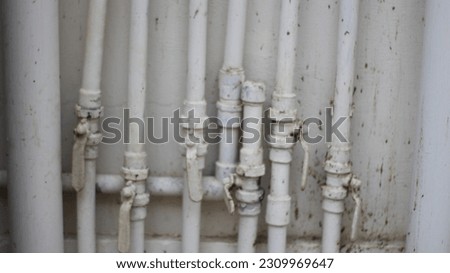 closeup pf pipe handle or tab,flow of water pipline , water pipelines attached to the wall.