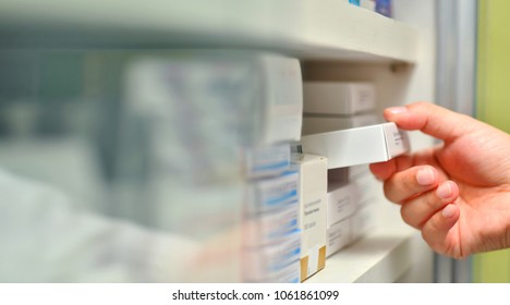Closeup Pharmacist Hand Holding Medicine Box In Pharmacy Drugstore.
