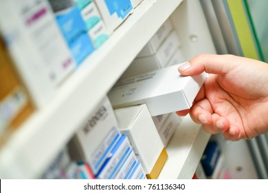 Closeup Pharmacist Hand Holding Medicine Box In Pharmacy Drugstore.