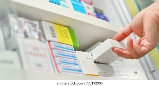 Closeup Pharmacist Hand Holding Medicine Box In Pharmacy Drugstore.