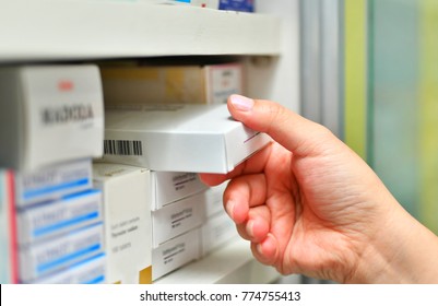 Closeup Pharmacist Hand Holding Medicine Box In Pharmacy Drugstore.