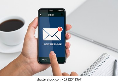 Closeup Of Phone With New E-Mail Message Notification In Females Hands Over Workplace Background. Email Chain, Modern Business Communication Application Concept. Cropped