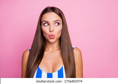 Closeup photo of adorable lady perfect straight hairstyle smooth bronze body skin send air kisses shy look side wear white blue striped bodysuit isolated pastel pink color background