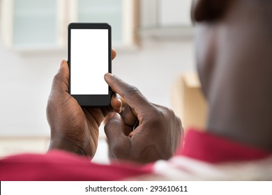 Close-up Photo Of  African Man Holding Cellphone
