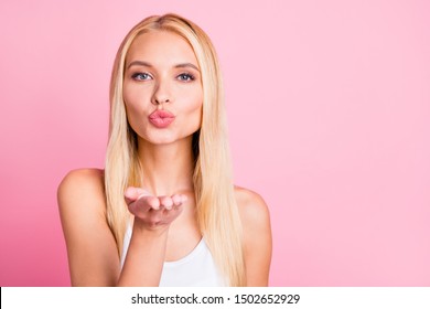 Closeup photo of amazing lady sending air kisses to handsome guy wear white tank-top isolated on pink color background