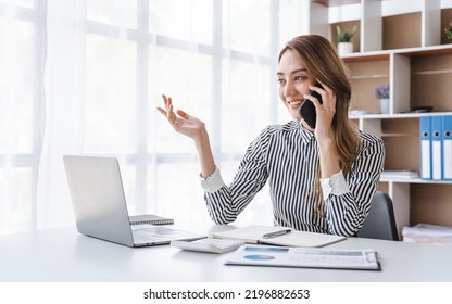 Close-up Photo Of Asian Office Woman Talking To Someone On A Cell Phone.