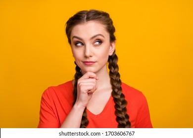 Closeup photo of attractive sly creative lady two long braids look side empty space have tricky idea arm on chin wear casual red t-shirt isolated bright yellow color background - Shutterstock ID 1703606767