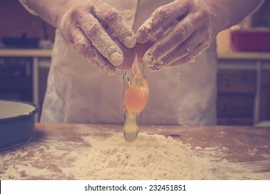 Closeup photo of baker cracking egg for dough. Retro styled imagery. - Powered by Shutterstock