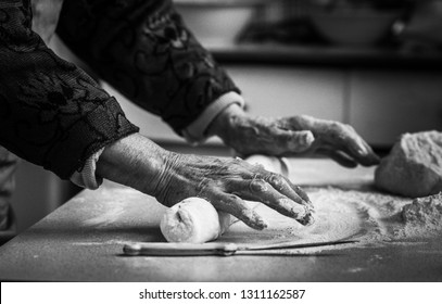 
Closeup Photo Of Baker Making Dough For Bread. Hands Of An Old Woman At Work With The Dough. Retro Look. 
Black And White Photo Of The Hands Of A Woman