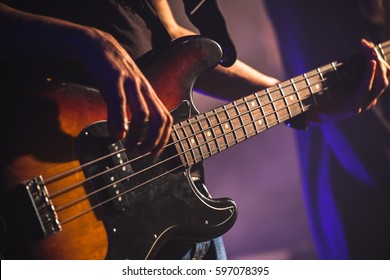 Close-up Photo Of Bass Guitar Player Hands, Soft Selective Focus, Live Rock Music Theme