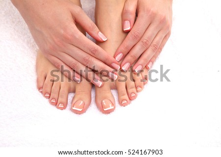 Closeup photo of a beautiful female feet with red pedicure isolated on white