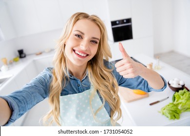 Closeup photo of beautiful housewife making selfies raise thumb finger up recording video vlog cooking blogger tasty vegan meal recommend stay home time kitchen indoors - Powered by Shutterstock