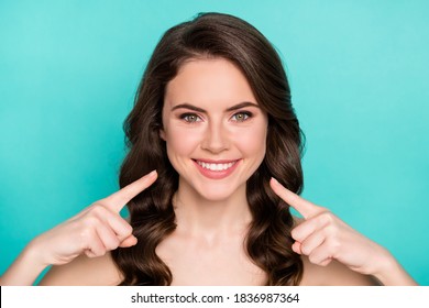 Closeup photo of beautiful naked curly lady demonstrating positive results direct fingers toothy beaming smile whitening procedure advice good dentist clinic isolated teal color background