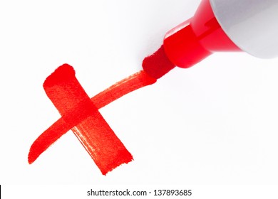 Close-up Photo Of A Big Red Felt Tip Marker Pen Writing A Cross X On White Paper