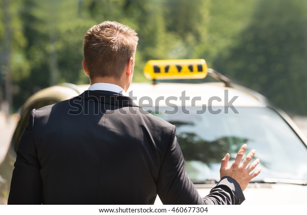 Close-up Photo Of A\
Businessman Calling\
Taxi
