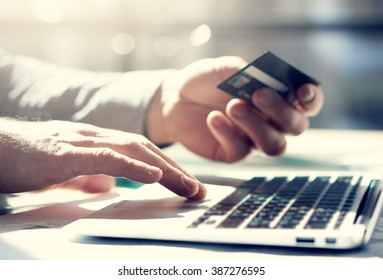 Closeup photo businessman working with generic design notebook. Online payments, hands keyboard. Blurred background, film effect. Horizontal