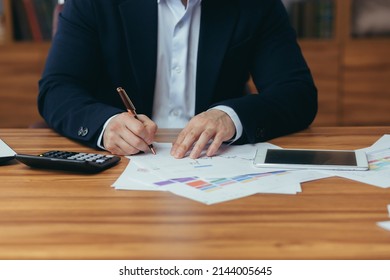 Close-up Photo Of Businessman's Hands Signing Documents At Desk, Man At Work In Business Suit