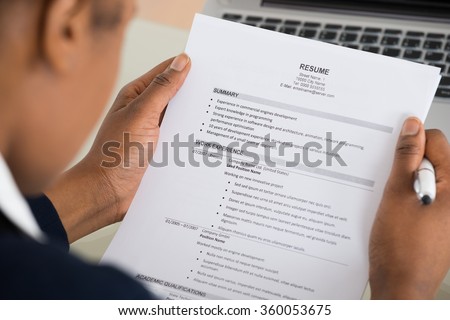 Close-up Photo Of A Businesswoman Holding Resume