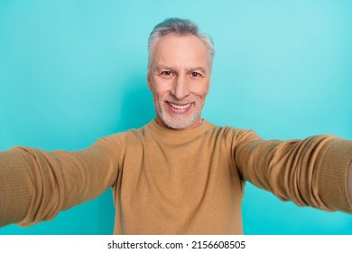 Close-up photo of cheerful handsome grandpa travel around globe take slefie isolated on teal color background