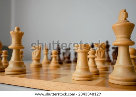 closeup photo of the chess board. Chess board on the round white table. Chess pieces lined up on the board. London System Sicilian defense. Game start	