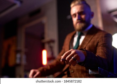 Close-up Photo Of Cigar In Hand On Confident Rich Guy Sitting In Dark Room Smoking Alone